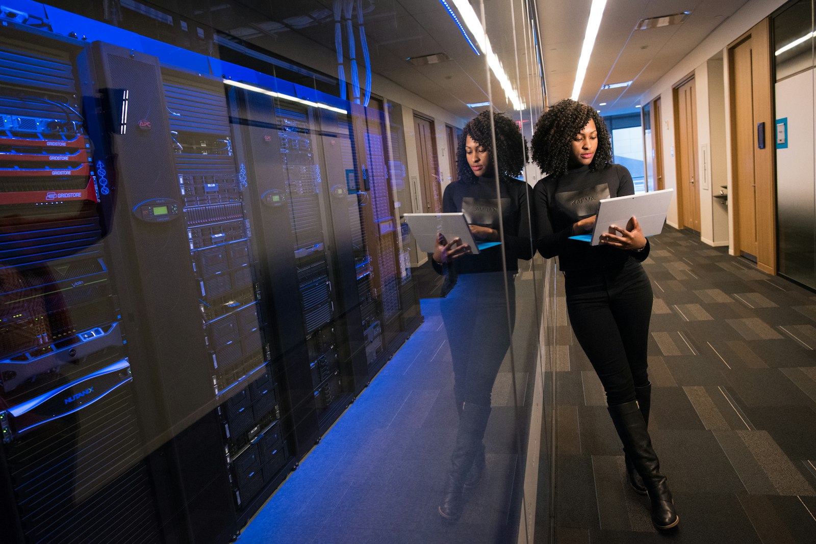 Engineer checking the go-live list beside server racks
